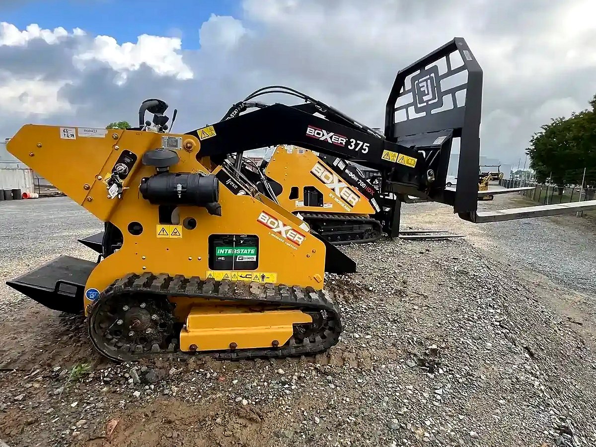 Boxer 375CE mini skid steer on the yard, shown with pallet forks